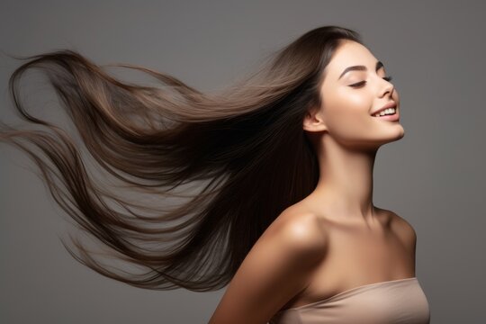 Profile Portrait Of A Beautiful Brunette Woman With Long Straight Hair On A Dark Gray Background