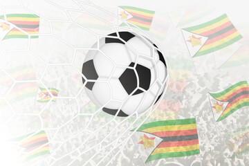 National Football team of Zimbabwe scored goal. Ball in goal net, while football supporters are waving the Zimbabwe flag in the background.
