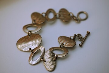 Closeup of a silver bracelet with an intricate design