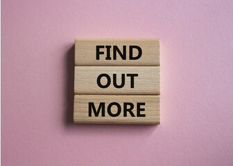 Find out more symbol. Concept word Find out more on wooden blocks. Beautiful pink background. Business and Find out more concept. Copy space
