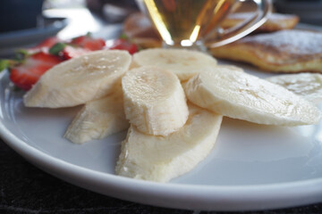 Collection of various fresh ripe banana slices on a plate 