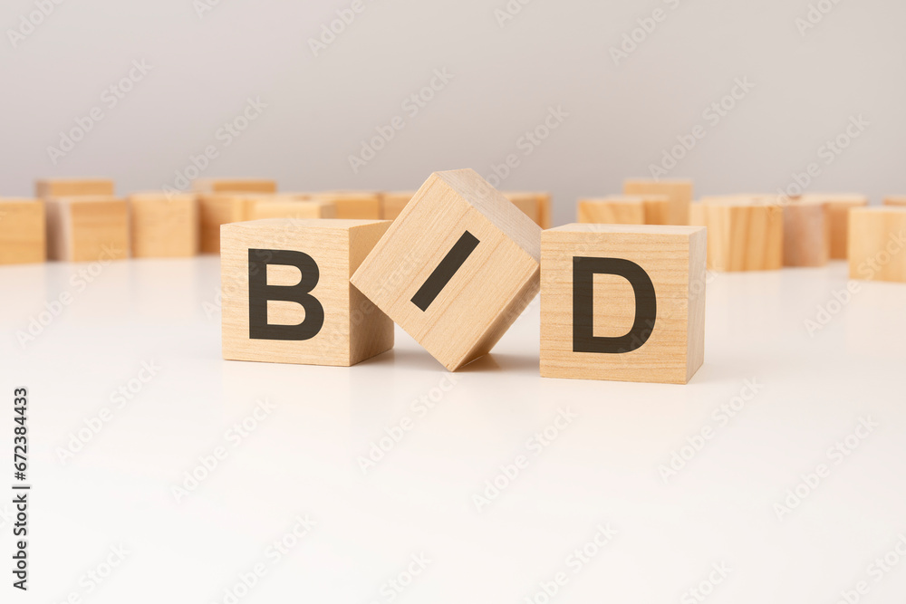 Poster three wooden cubes with bid symbols on them. white background. in the background there are many wood