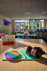 Ear Defenders Or Headphones And Fidget Toy To Help Child With ASD Or Autism On Table In School...