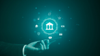 The concept of using digital technology for online banking. Businessman is holding a phone with...