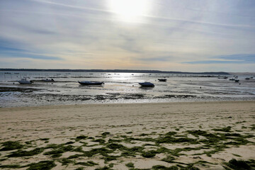 Evening on the shoreline at Cap Ferret looking across the Arcachon Bay towards the shoreline of...