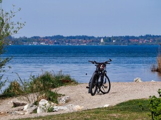 there is a bike parked in the sand on the shore