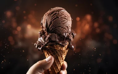 Foto auf Alu-Dibond Person hand holds chocolate ice cream in a waffle cone © GulArt