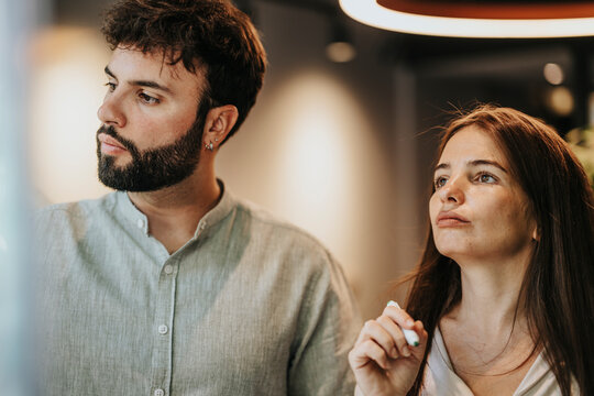 Collaborative Strategies: Creative Business Team Brainstorming and Planning in Modern Glass-Walled Office