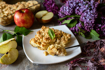 Crumble with apples on a white plate. Dessert with fruit. Close-up