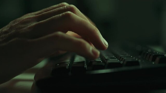 The hands of an IT specialist confidently move across the keys of a computer keyboard, creating program code. Illustration of remote work or distance learning. Working on a laptop computer