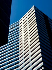 Fototapeta premium Exterior view of a modern building against the background of the blue sky.