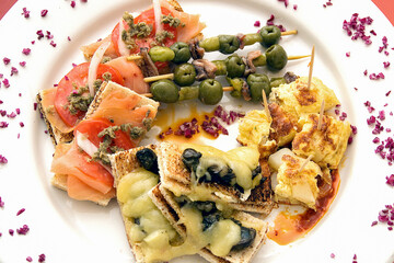Variety of canapés that include salmon, huitlacoche, grilled cheese and olive skewers to snack on