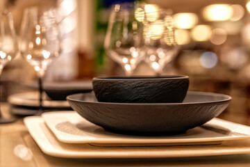 Beautiful modern tableware for restaurants, unusual background. Expensive interior.