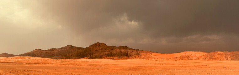 Tadrart and Tassili n'Ajjer mountains in the Algerian part of the Sahara, dark storm clouds,...