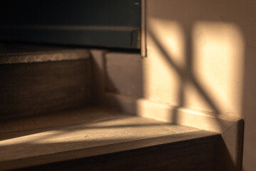 interior staircase steps window sunlight shadow warm background interior design detail copy space