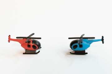 Closeup of two colorful helicopter miniatures isolated on white surface