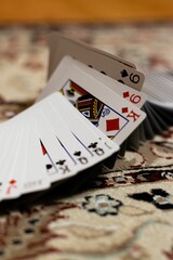 Vertical shot of playing cards deck scattered on the table