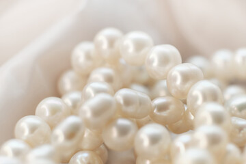 The soft focus pearls on a white canvas evoke a sense of calm and timeless beauty. This tranquil scene provides a respite from the relentless pursuit of the ultra-modern aesthetics.