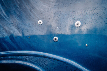 Closeup view of blue hot tub with jets