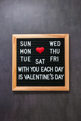Valentine's Day inscription on black letterboard. Love message concept. Vertical poster.