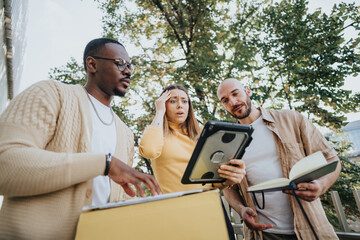 Business people collaborate outdoors in an urban city. They discuss ideas, market analysis, and financial planning. Together, they aim for growth, profitability, and successful start up funding.