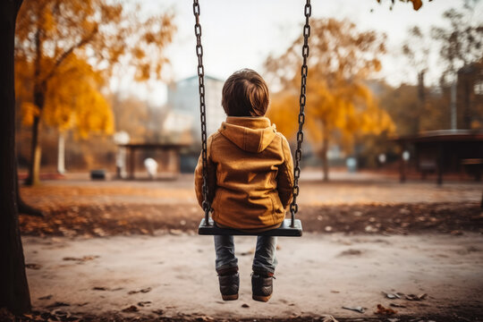 Child alone on playground swing background with empty space for text 