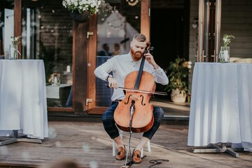 View of musician playing cello at the wedding. Musical Instrument