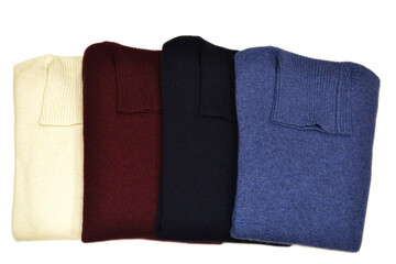Smooth turtleneck folded wool sweaters on isolated background