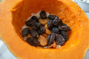 Dried fruits in peeled pumpkin for cooking.