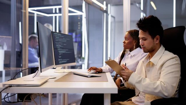 Computer Programmer Writing Program Code On Computer