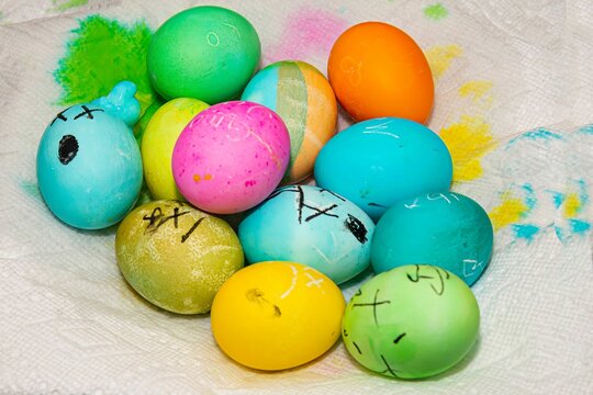 a pile of painted easter eggs laying on top of a table