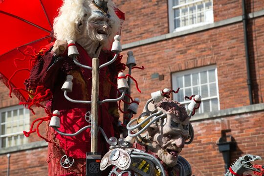 People dressed in medieval attire enjoying a sunny day at a festive event