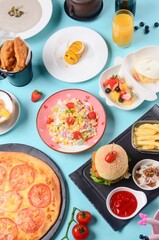 Top view of dishes from the Children's menu on a blue surface