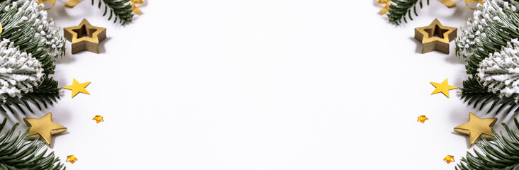 Long wide banner with fresh green fir branches and golden stars on white background with copy space for your design.