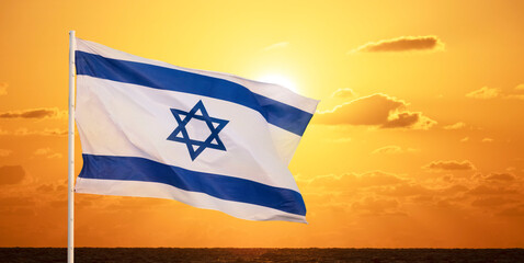 Flag of Israel in the wind against the background of the sea and with the yellow sky November 2, 2023 Tel Aviv 