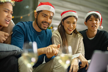 Fototapeta premium close up face of asian young teen calling through screen tablet to friends. party of people celebrating by technology online communication. friend female and male celebrating christmas at home.