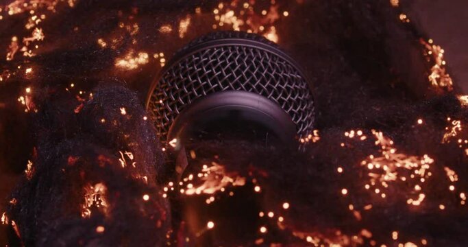 Burning studio microphone with bokeh light abstract wallpaper against dark background