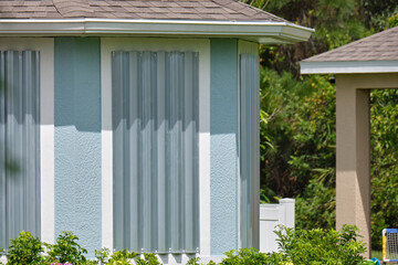 Boarded up windows with steel storm shutters for hurricane protection of residential house....