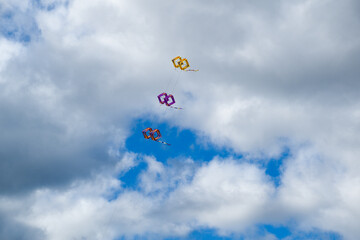 Kite flying in the sky against clouds. 