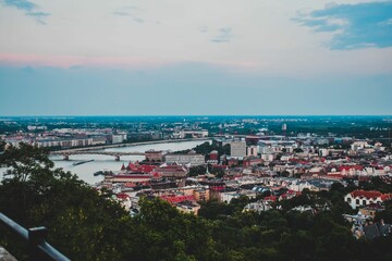 Fototapeta premium Aerial view of Budapest's vibrant city skyline in the evening, framed by the calm waters