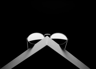 Pair of black shades isolated on a dark background.