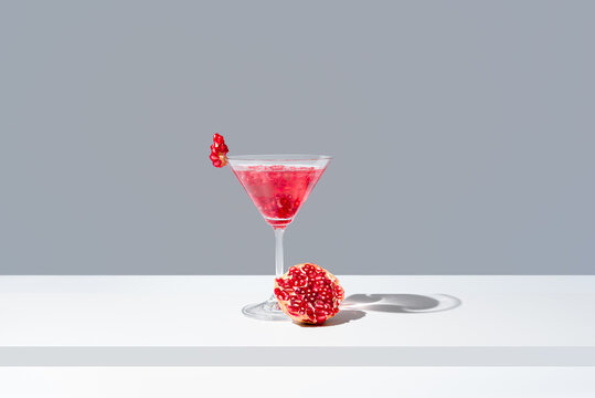Elegant pomegranate cocktail presentation with fresh pomegranate