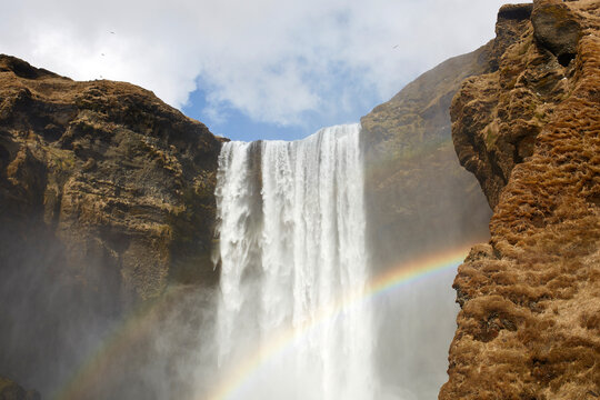 Rainbow near waterfall in nature