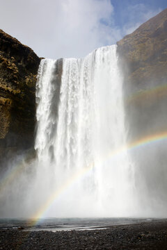 Rainbow near waterfall in nature