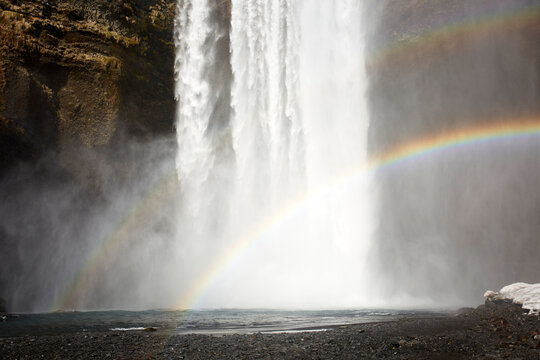 Rainbow near waterfall in nature
