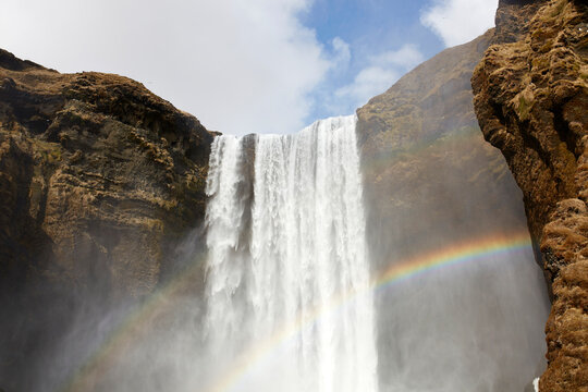 Rainbow near waterfall in nature