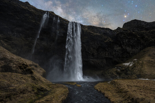Cascading waterfalls under starlit sky in Iceland