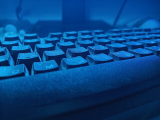 Detail of keyboard in low lighting in bluish hues