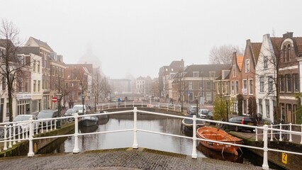 City landscape of Leiden with canals, dutch houses and boats.