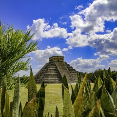 Ancient Chicen Itza ruins under a bright blue sky in Mexico